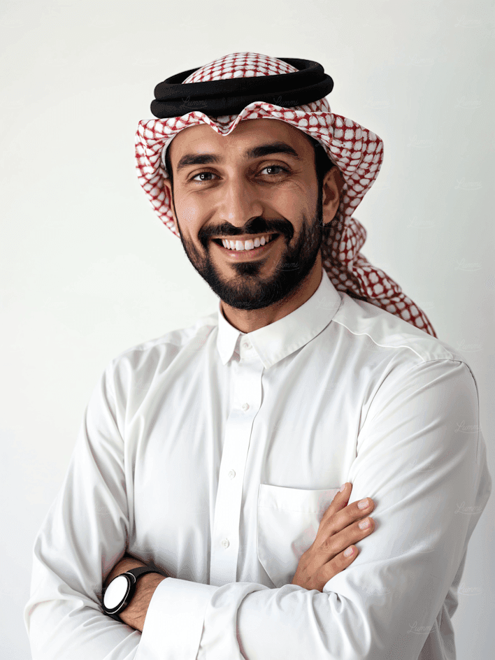 Headshot of a smiling man with a beard, wearing traditional Saudi headwear.